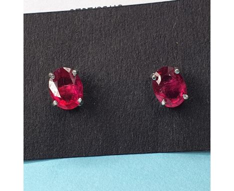 A pair of treated ruby and silver stud earrings 