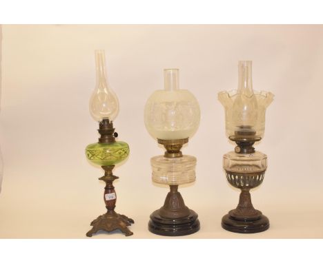 A late 19th/early 20th century spelter oil lamp with clear glass shade, and five others (6) 