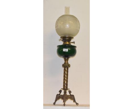A late 19th/early 20th century brass oil lamp with green glass well, 80 cm high 