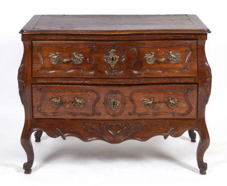 A late 18th/early 19th century French walnut bombe commode, having two drawers, on carved cabriole legs, 90 cm high x 110 cm 