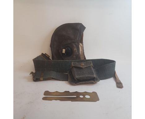 Five leather flying caps, a belt and a button polisher 