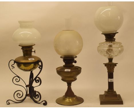 A late 19th/early 20th century brass and cast metal oil lamp, with white glass shade, and five others (6) 