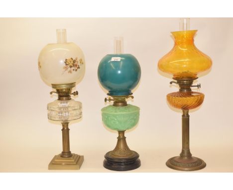 A late 19th/early 20th century brass oil lamp, with green glass well, and five others (6) 