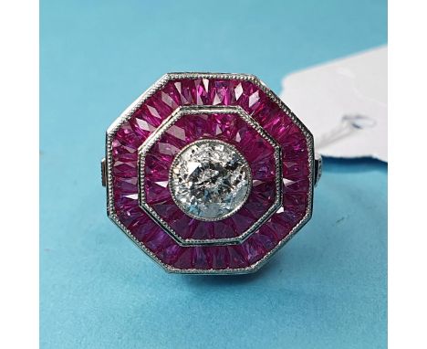 A platinum octagonal diamond and ruby ring, set with a central RBC diamond (1.00ct, approx) and two halos of calibre-cut rubi