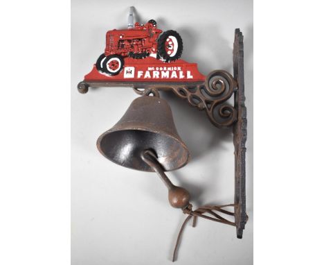 A Cold Painted Cast Iron Wall Hanging Door Bell in the Form of a Farmall Tractor, 37cms High 