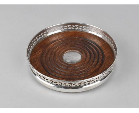 A Silver Plate and Wooden Bottle Coaster with Pierced Gallery, 13.5cms Diameter 