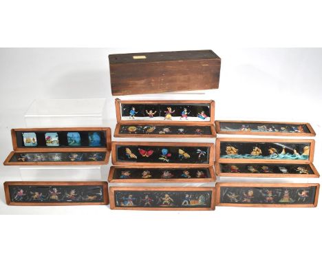 A Vintage Wooden Box with Sliding Lid Containing Coloured Magic Lantern Strip Slides, 26cm Long 