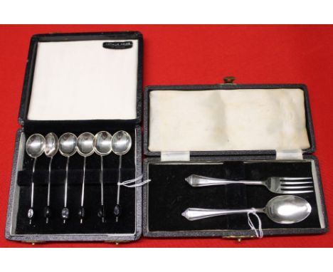 A cased set of silver coffee bean spoons and another cased silver spoon and fork set