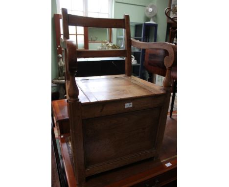 An early 20th century oak commode chair / thunder box
