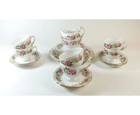 A Colclough tea service printed roses comprising jug, milk, six tea plates and a cake plate