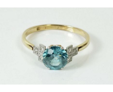 A gold ring set blue topaz on diamond set shoulders, size N, marks rubbed