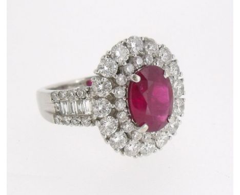 A fine 18 ct white gold ruby and diamond cluster ring, the central oval cut ruby 2.01cts within two row diamond surround and 