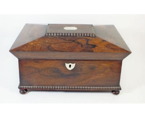 An early 19th century rosewood sarcophagus form tea caddy with mother of pearl inlay and fitted interior