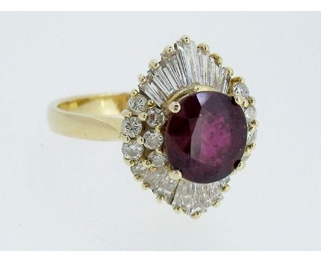 An 18ct gold 'ballerina' style ruby and diamond ring, the central ruby within baguette and brilliant cut diamond surround, si