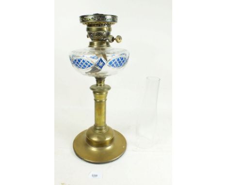 A Victorian cut glass oil lamp with blue flashed and cut decoration plus a later globe shade