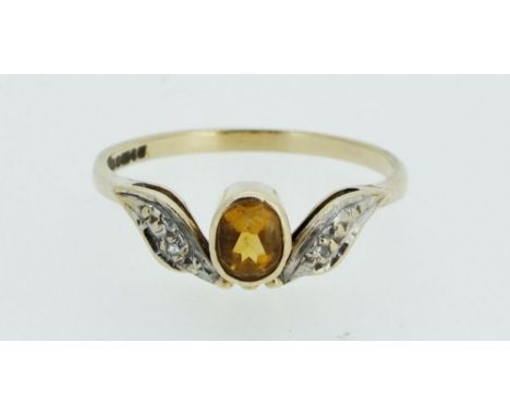 A 9 carat gold ring set yellow topaz and chip diamonds, size N