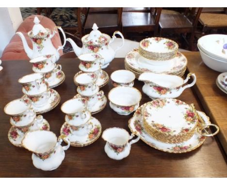 A Royal Albert Country Roses tea and dinner service comprising:- six dinner plates, eight side plates, six dessert bowls, six