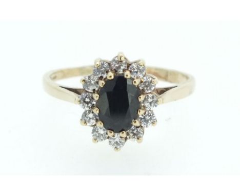 A 9 carat gold sapphire and white stone cluster ring - size N 1/2.