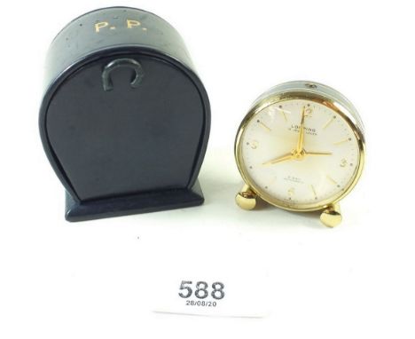 A small eight day travel alarm clock by Looping in its original case