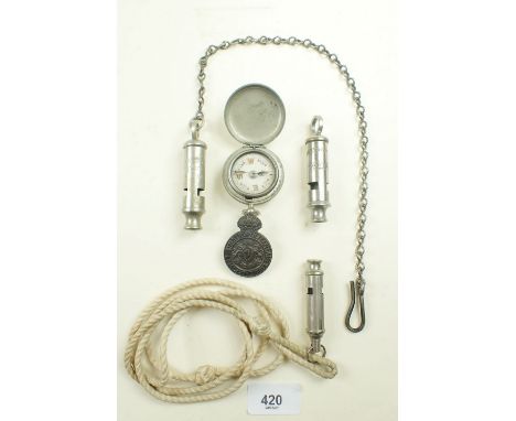 A group of whistles with compass and police badges