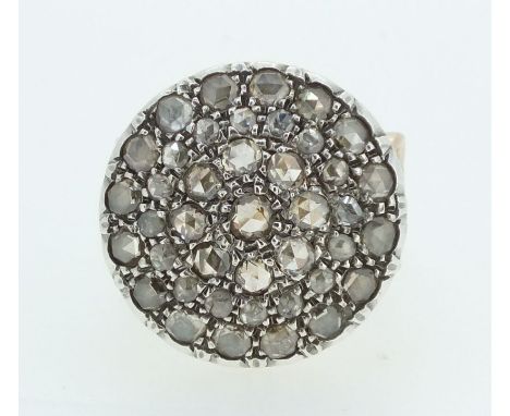 A large circular ring set rose cut diamonds on ornate gold scrollwork pierced and engraved band (unmarked), size N-O 