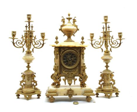 A French ormolu and veined marble clock garniture, late 19th century, the mantel clock with eight-day movement and griffin su