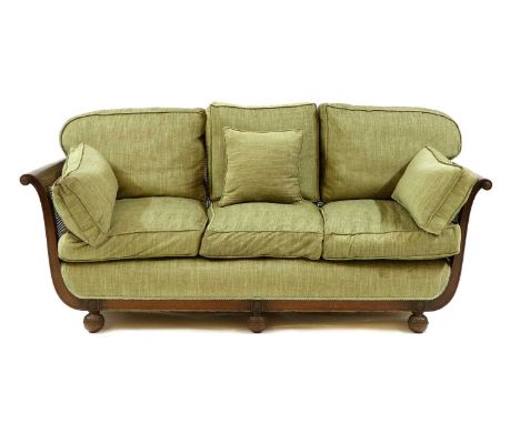 A three seat mahogany bergere sofa, with caned arms and back and feather cushions. 204cm long, 82cm deep, 87cm highCondition 