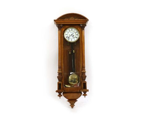 A late 19th century walnut 'Vienna regulator' clock, with two brass weights, striking the hours on a gong, dial signed 'Wilh.