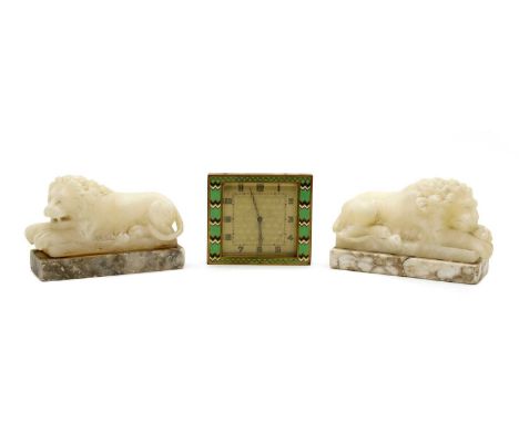 A mirrored pair of carved alabaster Canova style lions, each raised on a veined marble base, 14cm wide, together with a gilt 