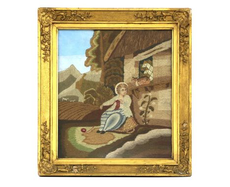 A needlework picture, 19th century, depicting a boy seated before a cottage playing with a kitten, 47 x 38cmCondition report: