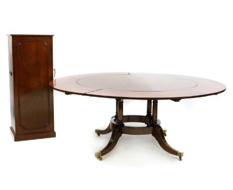 A Regency style mahogany circular extending dining table, 20th century, the circular top raised on turned column supports and