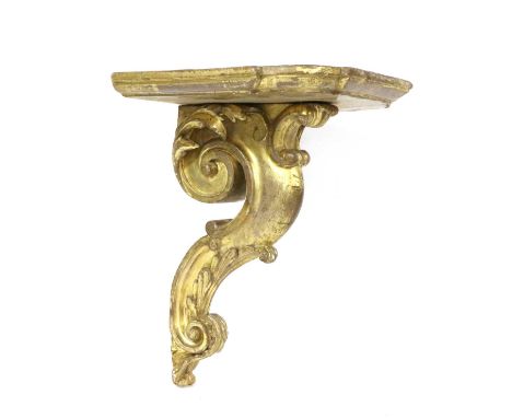 A carved giltwood wall bracket, 19th century, the shaped top on a scrolled support, 28cm wide, 23cm deep, 36cm highCondition 