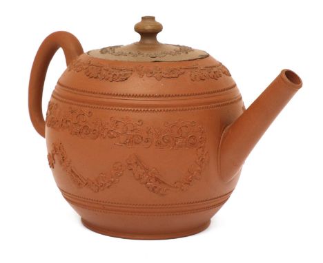 A Staffordshire redware globular teapot and cover,c.1770, with a loop handle, conical spout and turned knop, applied with ban