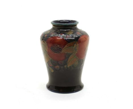 A Moorcroft 'Pomegranate' pattern baluster vase, early-mid 20th century, with tubeline decoration on a blue ground, painted a