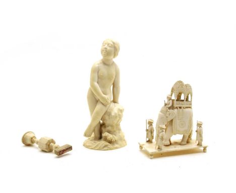 Three Ivory items, comprising: a Chinese carved solid ivory figure of naked woman leaning on a rock, signed beneath, 17cm hig