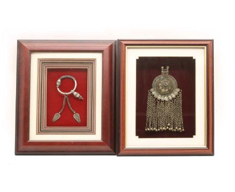 Two framed items of jewellery, to include a white metal bangle with beaded decoration and tassel drops, possibly Indian, and 