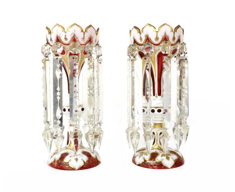 A pair of ruby and overlaid white glass table lustres, with gilt highlights and clear glass prismatic drops, 33cm high (2)Con