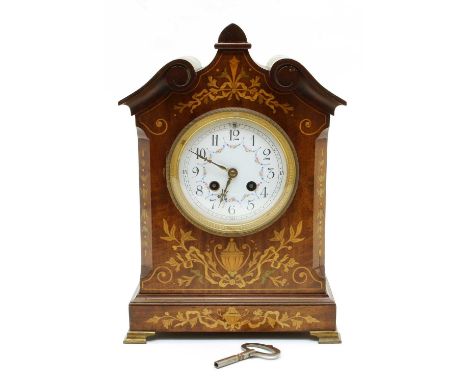 An Edwardian mahogany and inlaid mantle clock on brass bracket feet, with a painted dial to a French 8-day movement striking 