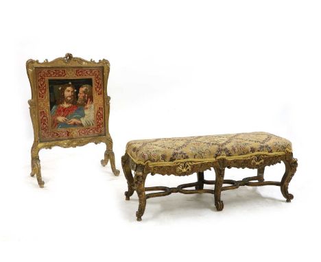 A carved gilt duet stool, 116cm wide, 42cm deep 45cm high, and a carved firescreen, centred with Jesus and a disciple, 70cm w