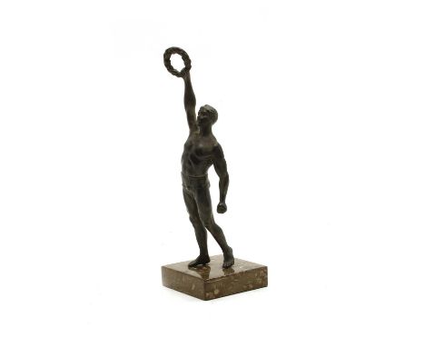 A bronzed figure of an athlete, holding aloft a laurel wreath, on a square green stone base, 23cm highCondition report: Light