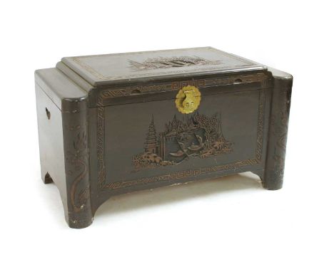 A Chinese or Korean camphorwood trunk, early 20th century, with carved decoration and an internal tray, 100cm wide, 54cm deep