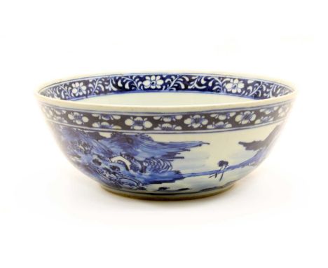 A Chinese blue and white bowl, probably early 20th century, but bearing Kangxi marks, decorated in the round with figures in 