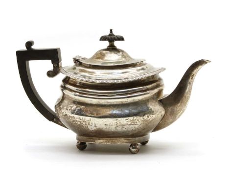 A sterling silver teapot, of oval form with ball feet, by George Edward &amp; Sons, London 1916, with presentation inscriptio