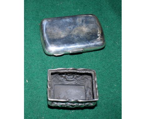 A plain curved silver cigarette case with presentation inscription and a rectangular repoussé decorated silver salt, 3.4oz tr