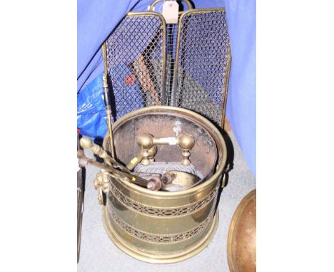 A folding brass wire work fireguard, a number of fire implements, a pair of implement rests and a brass coal vase and cover