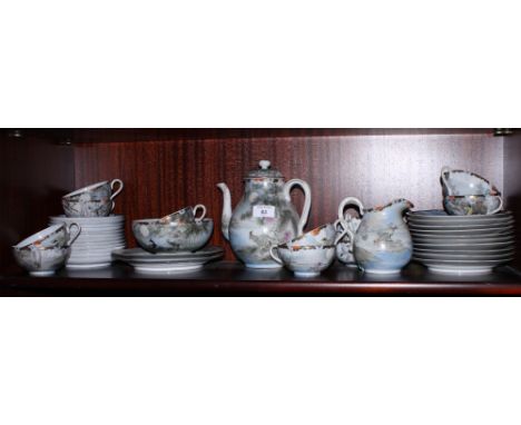 A Japanese eggshell porcelain tea service decorated birds and foliage