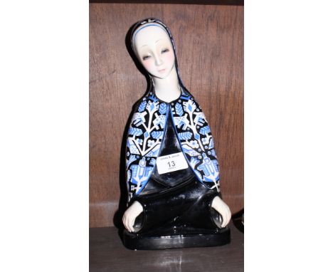 A Lenci pottery figure of the Madonna modelled with crossed arms wearing a hooded cloak decorated with stylised animals, 11" 