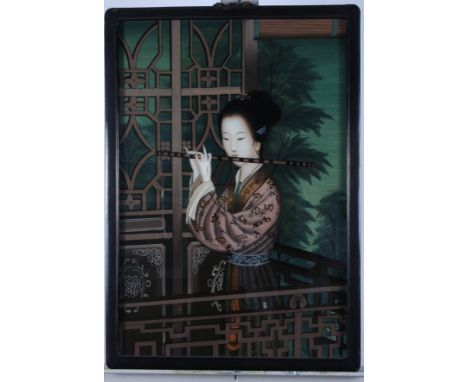 A Chinese reverse painted glass panel, girl playing a flute, in ebonised frame