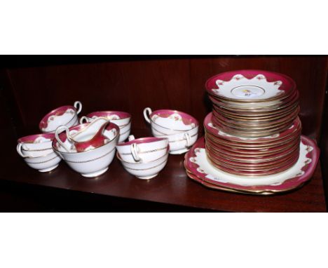 A Chelson part tea service decorated floral centres on a red ground