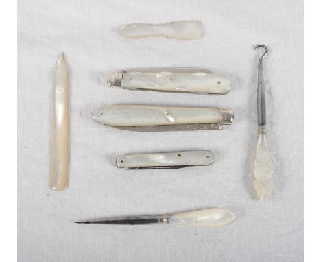 Two silver and mother-of-pearl fruit knives, another similar, a mother-of-pearl handled button hook and a similar manicure im